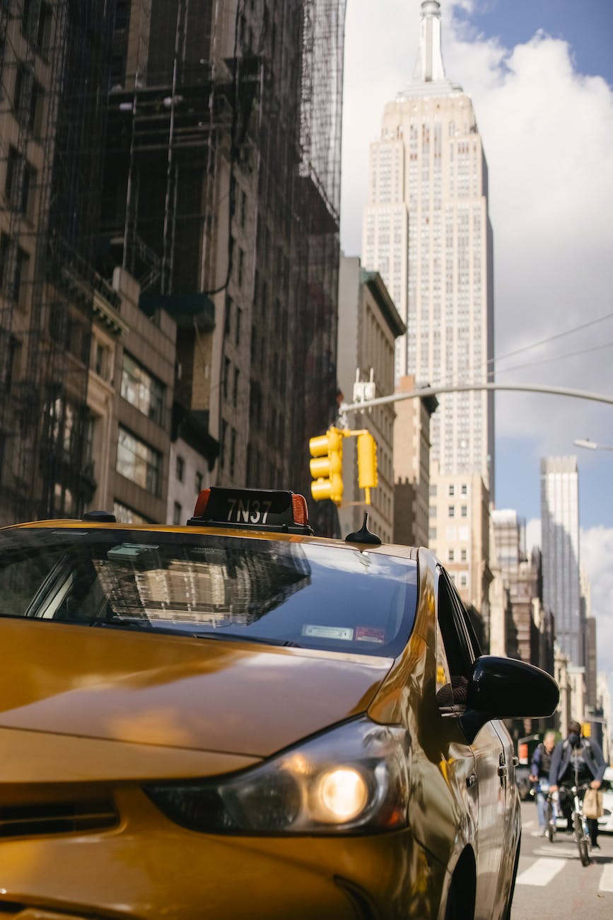 modern taxi car with shiny headlight on urban road